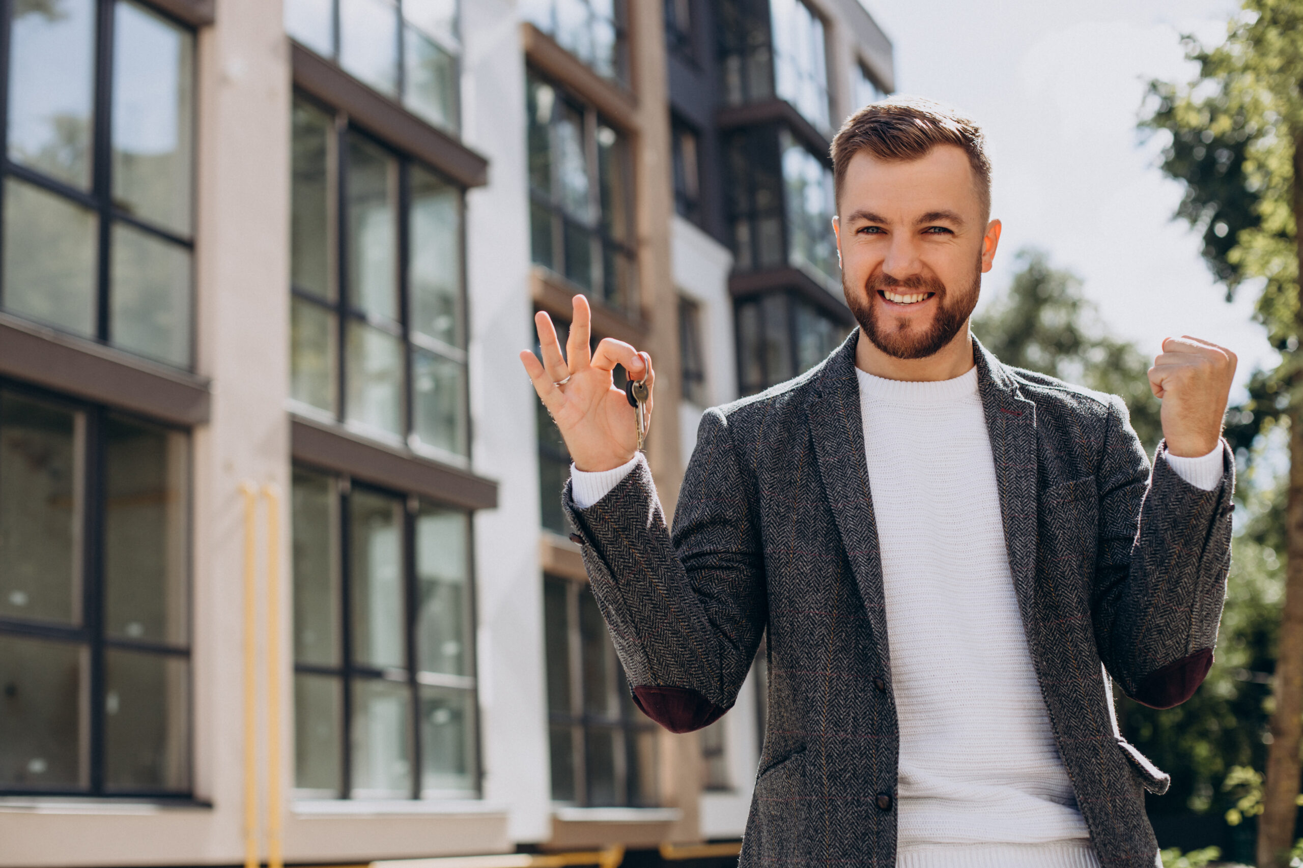 Young man with keys just bought new appartment